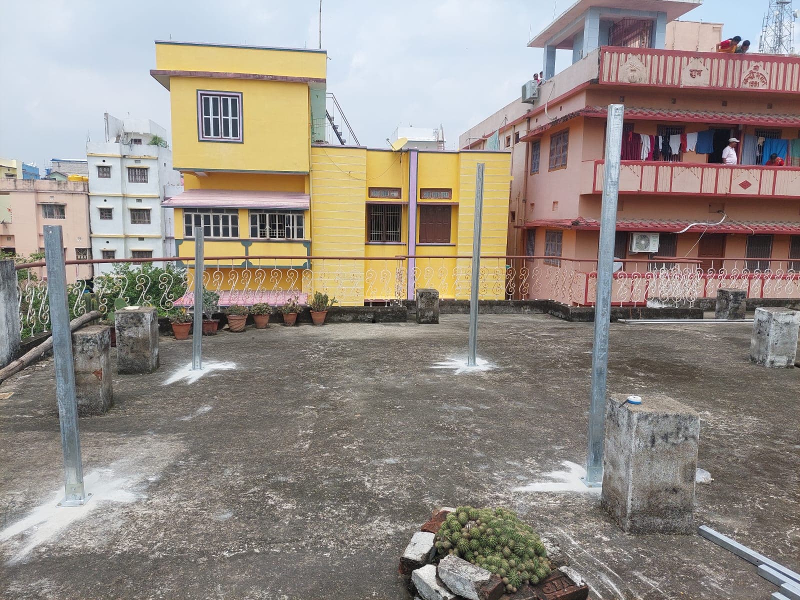 Steel mounting posts arranged on the residential rooftop before panel installation.
